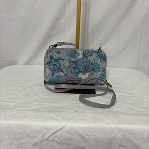 Sakroots Smartphone Wallet in a grey ocean/seascape pattern.